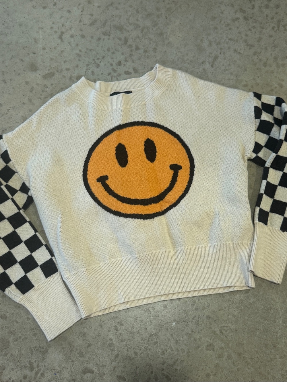 Cream Smiley Face Crewneck Sweater with Checkerboard Sleeves
